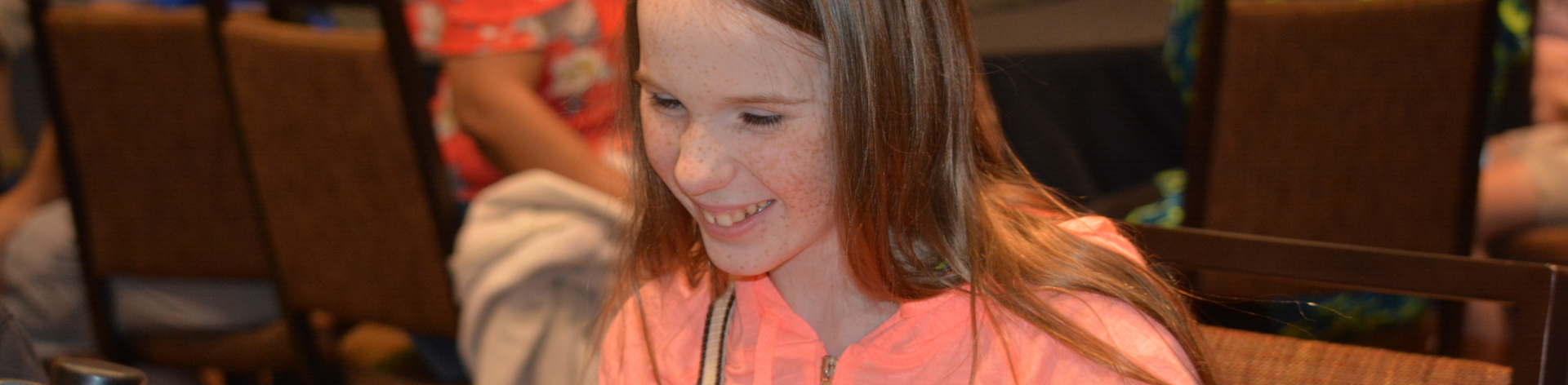 Smiling girl at a table